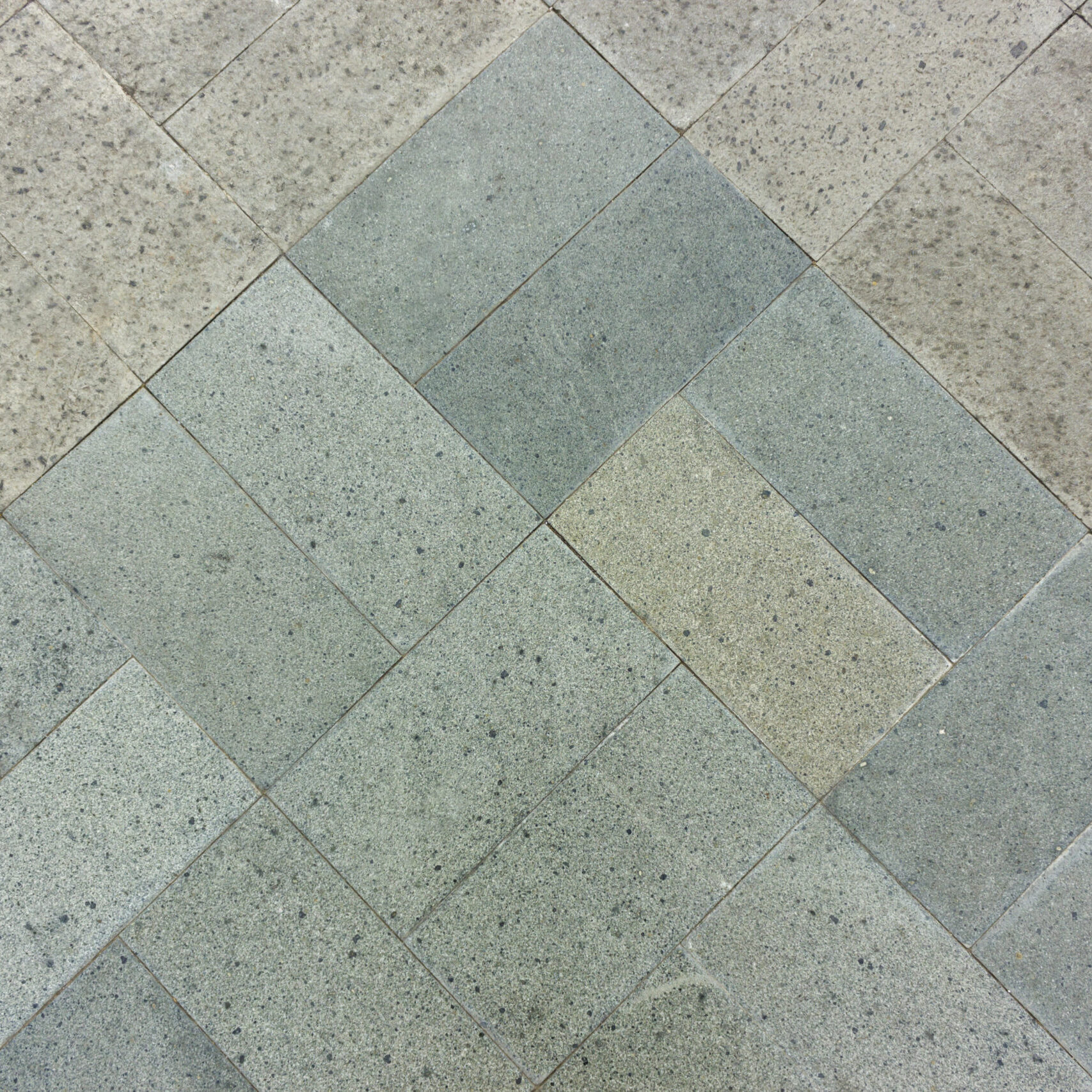 Paver stones in various shades of gray arranged in a geometric pattern, showcasing durability and aesthetic appeal for outdoor spaces in Scottsdale, AZ.